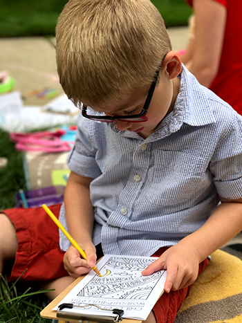 Child using Children's Worship Bulletins