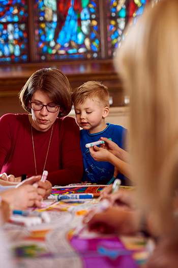 Parent and Child Coloring Together in Church