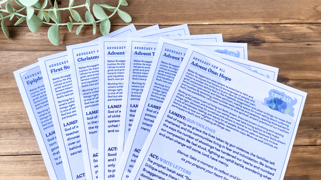 Printed pages of Illustrated Ministry’s Advocacy for All bulletin inserts for Advent through Epiphany displayed on a wooden table with greenery.
