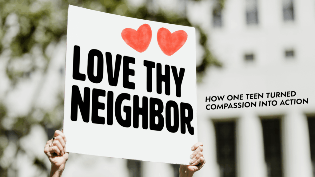 A person holds a sign reading “Love Thy Neighbor” with two red hearts, symbolizing compassion and community action.