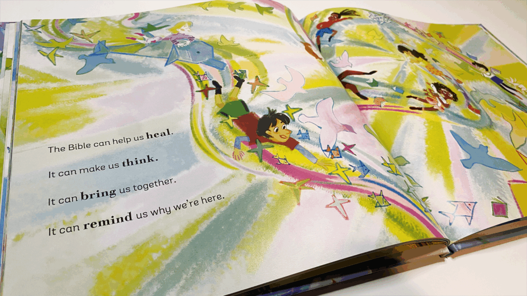 An open spread from What is the Bible? with colorful swirling illustrations of children moving through streaks of yellow, green, and blue. The text reads: “The Bible can help us heal. It can make us think. It can bring us together. It can remind us why we’re here.”