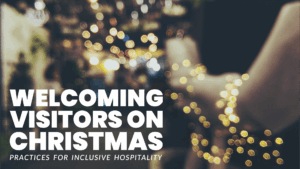 A blurred image of warm holiday lights with bold white text reading “Welcoming Visitors on Christmas: Practices for Inclusive Hospitality.”