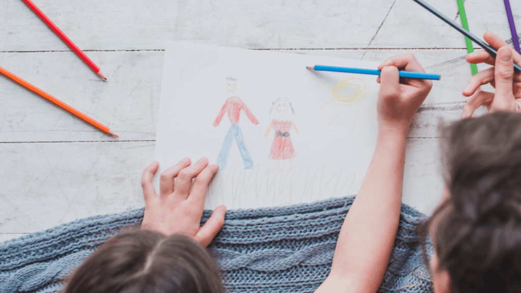 A child and grown-up coloring together.