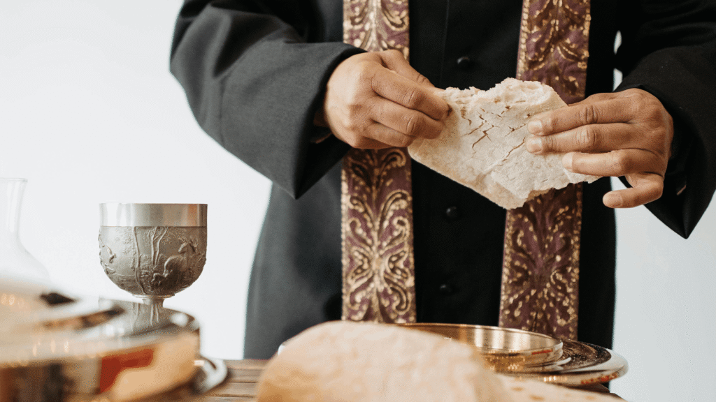 Pastor breaking bread during communion in a church service, symbolizing community and shared participation